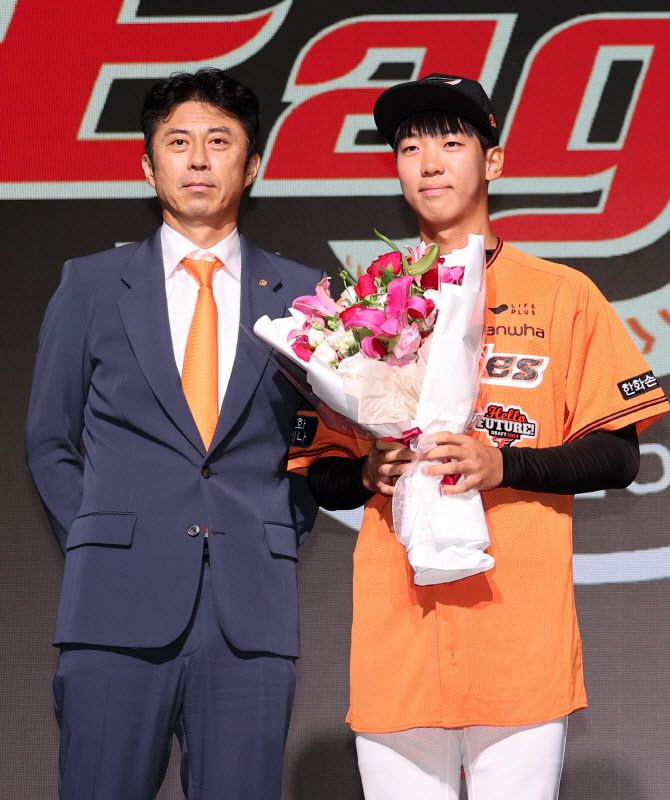 14일 오후 서울 중구 웨스틴조선호텔 그랜드볼룸에서 열린 ‘2024 KBO 신인 드래프트’에서 한화 이글스 1라운드 1순위로 지명된 황준서(장충고)가 손혁 단장(왼쪽)과 기념 촬영을 하고 있다. 사진=뉴스1