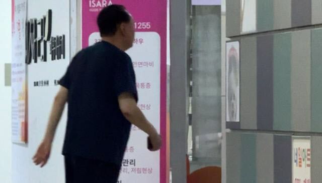 윤석열 전 대통령이 경찰 특별수사단의 2차 출석 요구일인 12일 오전 반팔에 반바지 차림으로 서울 서초구 아크로비스타 상가 안에서 걸어 다니고 있다. (사진=한국일보)