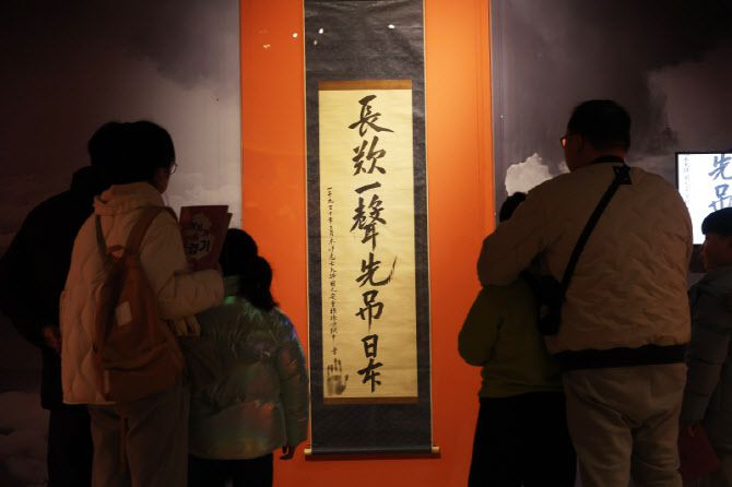 경기도 용인시 경기도박물관에서 열리고 있는 특별전 '동양지사, 안중근-통일이 독립이다'에서 관람객들이 안중근 의사의 유묵 '장탄일성 선조일본(長歎一聲 先弔日本)'을 살펴보고 있다. (사진=연합뉴스)