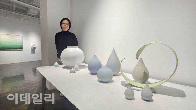 작가 조원재가 갤러리조은 ‘평온의 가장자리’ 전에 내놓은 자신의 작품들을 내려다 보고 있다. 멀리 성연화의 한지회화 ‘흐름’(Flow 258-000-020 2025, 116.8×91.0㎝)이 보인다(사진=오현주 문화전문기자).