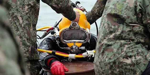 2014년 4월 해군 SSU 소속 군인이 세월호 수색 작업을 위한 잠수를 마치고 바지선 위로 오르고 있다. /연합뉴스