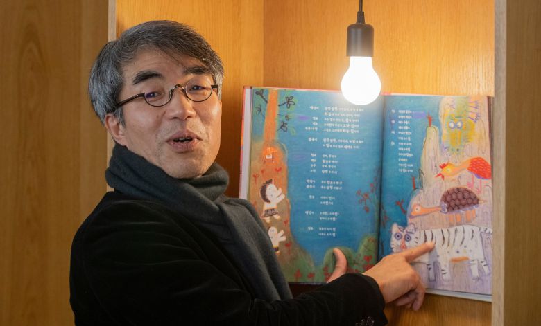 극작가 배삼식이 자신의 첫 희곡 그림책 ‘훨훨 올라간다’에서 뒷산이 돼 잠들어 있던 전설 속 동물들이 깨어나 하늘로 돌아가려 하는 장면을 펼쳐 보이고 있다. 그는 “아이들이 역할을 나눠 읽으며 함께 즐겁게 놀기를 바라면서 쓴 이야기”라고 했다 /박상훈 기자