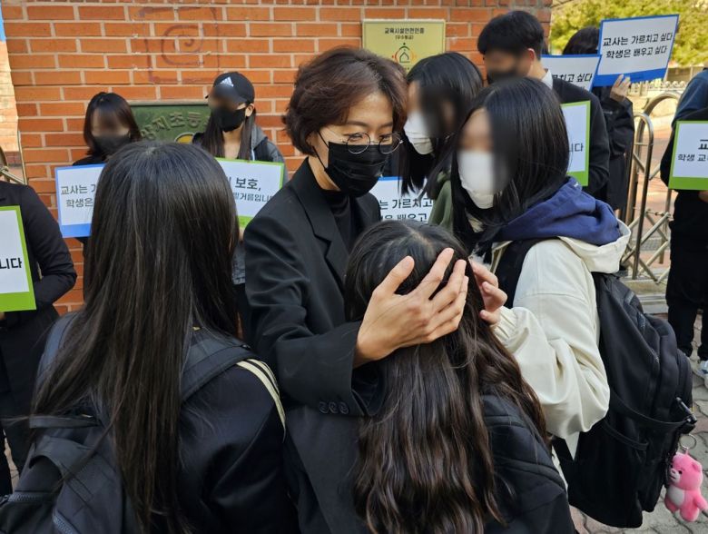 10월 24일 광주시 북구 한 초등학교 앞에서 열린 교권회복 촉구 집회에서 하교 하던 학생들이 윤모 교사에게 인사하고 있다.  /뉴스1