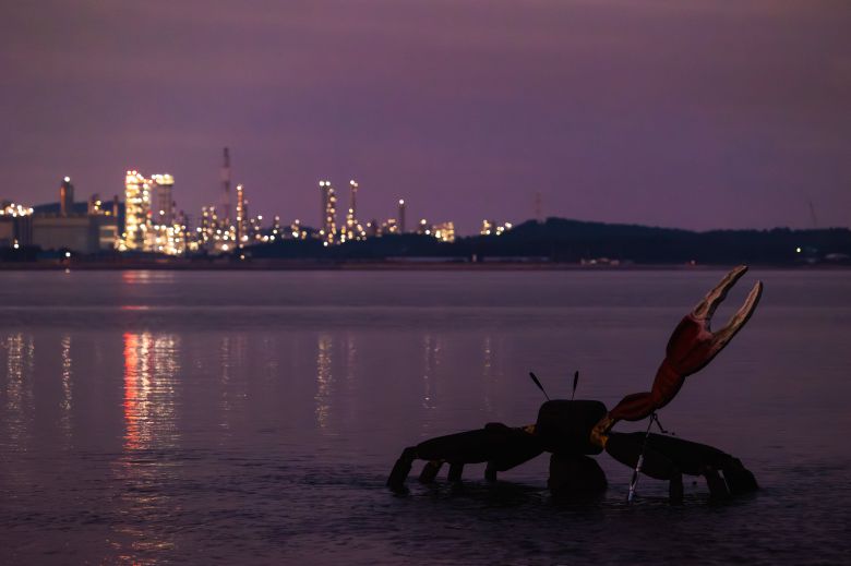 멸종위기종 흰발농게 서식지를 알리는 벌천포의 흰발농게 조형물. 해가 저물자 조형물 뒤편으로 대산공단의 야경이 점점 또렷해지며 이색 풍경을 연출한다. / 이건송 영상미디어 기자