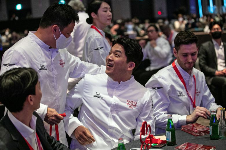 Chef Anh Sung-jae (center) is congratulated by fellow chefs after receiving three stars in the 2023 Michelin Guide. /News1