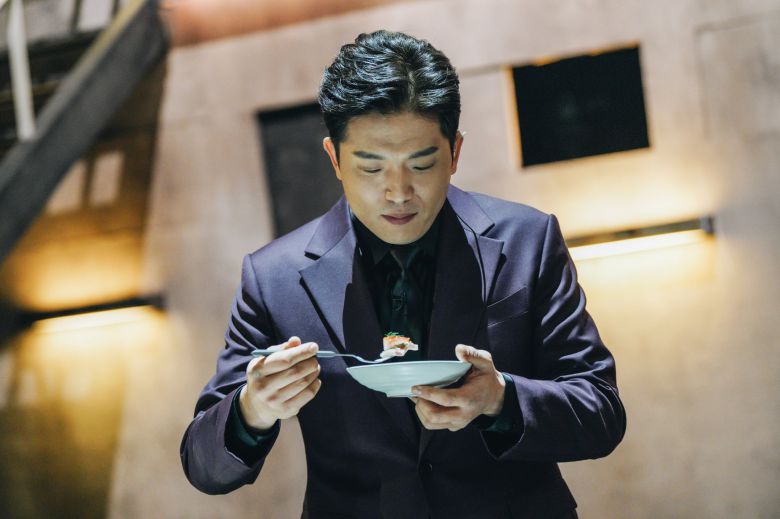 Chef Anh Sung-jae tastes a dish prepared by a contestant on Netflix's Culinary Class Wars. / Netflix