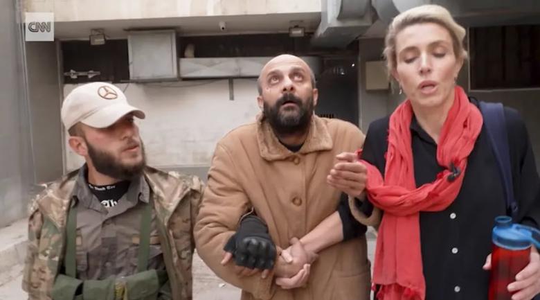 클래리사 워드(오른쪽) CNN 기자와 함께 수용소 바깥으로 나온 무함마드 살라마(가운데)가 하늘을 올려다 보고 있다. 석 달간 창문 없는 독방에 갇혀 있었다는 그가 하늘을 바라보면서도 움츠리지 않아 그의 주장을 믿기 어렵다는 지적이 제기됐다. /CNN