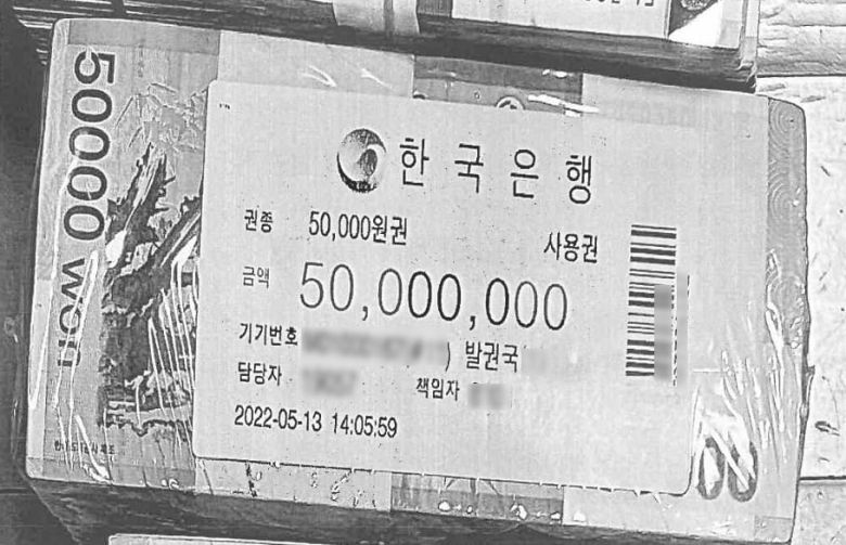 검찰은 지난해 무속인 '건진법사' 전성배씨 자택에서 압수한 5000만원 신권 '뭉칫돈'의 출처를 추적하고 있다. 사진은 전씨의 자택에서 나온 한국은행이 적힌 비닐로 포장된 관봉권 돈뭉치. /연합뉴스