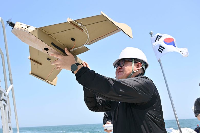 지난 12일 울산 일산항 인근 해상에서 진행된 해군 주관 '전·평시 상용 무인체계 작전 운용 가능성 검증훈련'에 참가한 드론 운용 민간 요원이 선박해양플랜트연구소 해양누리호 갑판에서 골판지 드론 이륙을 준비하고 있다./해군