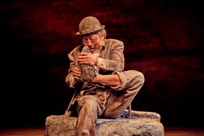 연극 '고도를 기다리며'에서 구두를 벗으려고 끙끙대는 에스트라공(신구). /파크컴퍼니