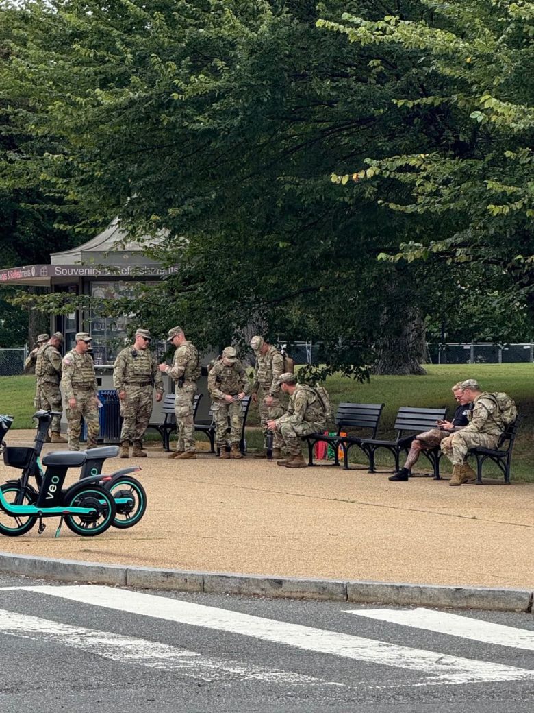 트럼프 지시로 워싱턴에 투입된 주 방위군들이 나무 그늘 아래 벤치에 앉아 휴식을 취하고 있다. /박국희 특파원