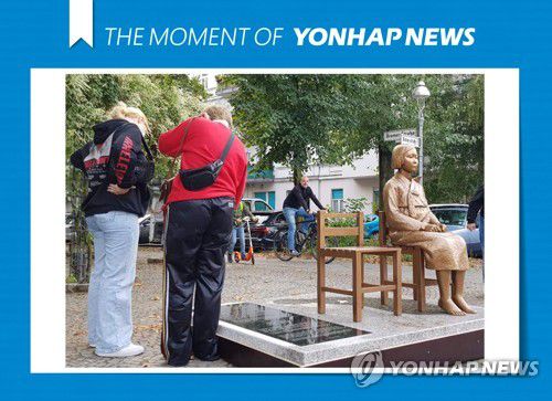 [모멘트] 베를린 거리에 설치된 소녀상 비문 읽는 시민들(베를린=연합뉴스) 이광빈 특파원 = 지난 25일(현지시간) 독일 수도 베를린에 설치된 '평화의 소녀상'에 쓰인 비문을 지나가던 시민들이 읽고 있다. 독일에서 소녀상이 설치된 것은 이번이 세 번째인데, 공공장소에 세워진 것은 이번이 처음이다.2020.9.27 [THE MOMENT OF YONHAPNEWS] lkbin@yna.co.kr