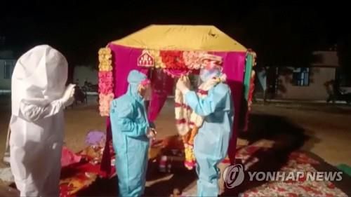 결혼식 직전 코로나19에 확진돼 방호복 차림으로 식을 치른 인도 부부 [로이터=연합뉴스. 재판매 및 DB 금지]