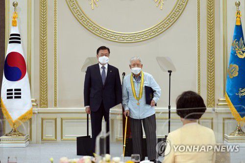 포상수여하는 문재인 대통령(서울=연합뉴스) 최재구 기자 = 문재인 대통령이 24일 청와대에서 열린 국가유공자 및 보훈가족 초청 오찬 행사에서 하사용 참전용사에게 국민훈장 동백장을 수여하고 있다. jjaeck9@yna.co.kr