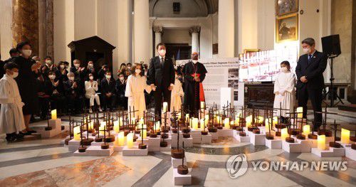 LED 촛불 점등식 하는 문재인 대통령(로마=연합뉴스) 최재구 기자 = 문재인 대통령과 김정숙 여사가 29일(현지시간) 이탈리아 로마 산티냐시오 디 로욜라 성당에서 열린 '철조망 평화가 되다' 전시회에서 한반도를 형상화한 전시작품의 LED 촛불 점등식을 하고 있다. 2021.10.29 jjaeck9@yna.co.kr