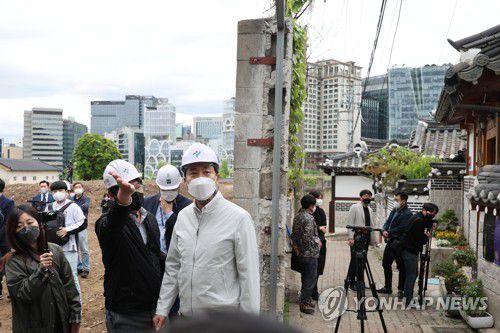 '여기가 개방 앞둔 청와대로 가는 지름길'(서울=연합뉴스) 김주성 기자 = 오세훈 서울시장이 29일 오후 서울 종로구 송현동 부지 개방 계획을 점검한 뒤 청와대와 국립현대미술관 방향으로 낸 문을 통해 나가고 있다.        서울시는 '이건희 기증관(가칭)'이 들어설 예정인 송현동 부지를 '쉼과 문화가 있는 열린 공간'으로 조성해 올 하반기 광화문광장 재개장 시기에 맞춰 함께 개방하기로 했다. 2022.4.29 utzza@yna.co.kr