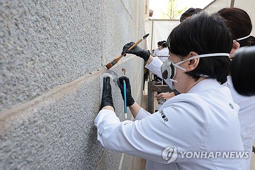 낙서로 훼손된 영추문 담장, 2차 보존 처리작업(서울=연합뉴스) 김인철 기자 = 18일 서울 종로구 경복궁 영추문에서 지난해 말 스프레이 낙서로 훼손된 궁궐 담장에 2차 보존 처리 작업이 진행되고 있다. 2024.4.18 yatoya@yna.co.kr