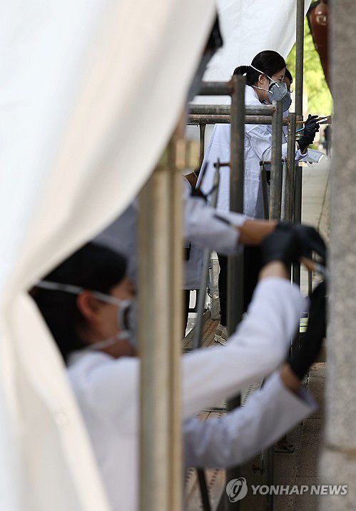 낙서로 훼손된 경복궁 담장, 추가 보존 처리(서울=연합뉴스) 김인철 기자 = 18일 서울 종로구 경복궁 영추문에서 지난해 말 스프레이 낙서로 훼손된 궁궐 담장에 2차 보존 처리 작업이 진행되고 있다. 2024.4.18 yatoya@yna.co.kr