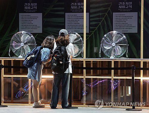 '바람과 함께 휴식'(서울=연합뉴스) 서대연 기자 = 서울 전역에 폭염주의보가 내리며 더운 날씨를 보인 24일 저녁 시민들이 서울 종로구 광화문광장 물놀이 건조시설에서 바람을 쐬고 있다. 2024.7.24 dwise@yna.co.kr