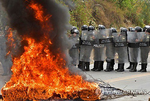 모랄레스 지지자 시위 막는 볼리비아 경찰(파로타니 로이터=연합뉴스) 25일(현지시간) 볼리비아 파로타니에서 경찰이 불타는 도로 위 바리케이드 인근에서 시위 질서 유지 임무를 하고 있다. 2024.10.28