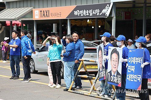 제주민속오일시장서 민주당 첫 유세(제주=연합뉴스) 박지호 기자 = 6·3 대통령선거 공식 선거운동 첫날인 12일 오전 제주시 민속오일시장에서 더불어민주당 제주선대위 관계자들이 이재명 후보 지지를 호소하고 있다. 2025.5.12 jihopark@yna.co.kr