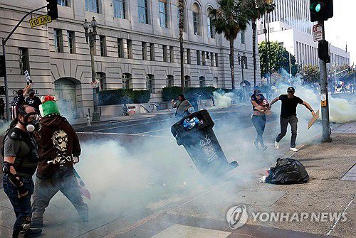 14일 LA 시청 앞 거리에서 최루탄으로 시위대를 해산시키는 경찰[AFP=연합뉴스. 재판매 및 DB 금지]