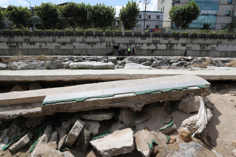 16일 낮 서울 관악구 도림천에서 공사 관계자들이 파손된 산책로 너머로 복구 작업을 하고 있다. 신소영 기자