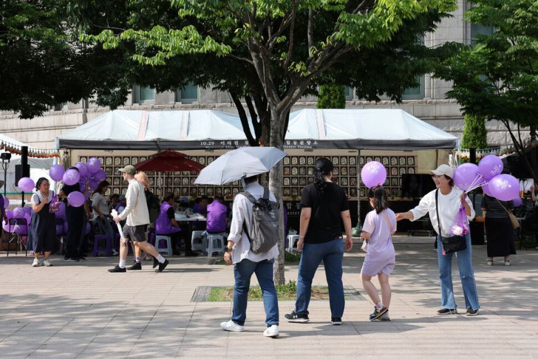 유가족들이 15일 오후 합동분향소에서 시민에게 보라색 풍선과 보라 선물꾸러미를 나눠주고 있다. 김영원 기자