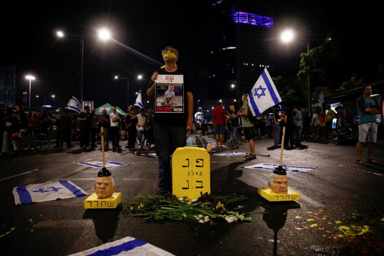 2일(현지시각) 이스라엘 텔아비브에서 열린 베냐민 네타냐후 정부 반대 시위에 참석한 사람들이 가자지구에 억류된 모든 인질을 석방하라고 요구하고 있다. 바닥에는 네타냐후 총리의 모습이 담긴 가면이 놓여있다. 텔아비브/로이터 연합뉴스