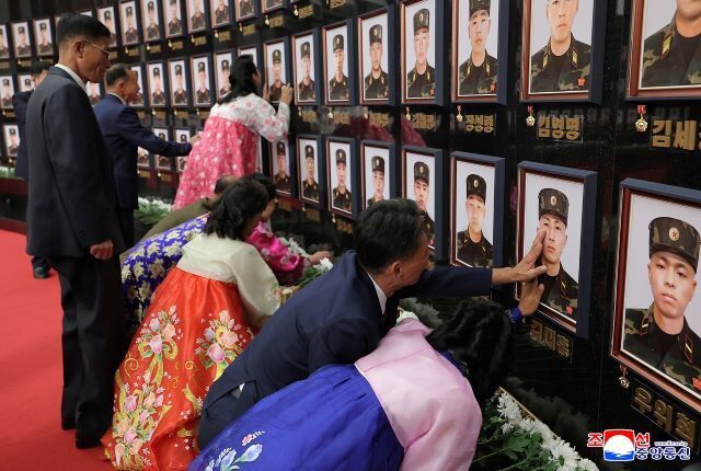 평양 조선노동당 중앙위 본부청사에서 열린 러-우전쟁 참전 인민군 ‘국가표창수여식’에 참석한 전몰 인민군 유가족들이 ‘당중앙회관’에 세워진 ‘추모의 벽’ 앞에서 자기 아들의 영정을 쓰다듬으며 오열하는 모습. 조선중앙통신 연합뉴스
