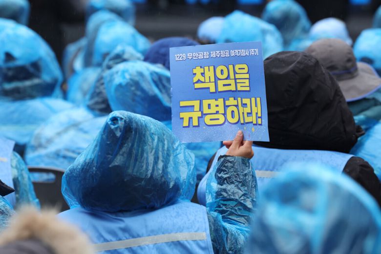 20일 오후 서울 종로구 보신각 광장에서 열린 1229 무안공항 제주항공 여객기 참사 1주기 서울시민추모대회에서 유가족이 진실규명을 촉구하는 손팻말을 들고 있다. 김태형 기자