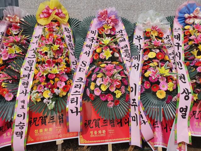 23일 오후 대구 달성군 유가읍 쌍계리 박근혜 전 대통령 사저 담벼락에 미국에서 SF 크리스티나 라고 쓰인 화환이 놓여 있다. 류수현 기자