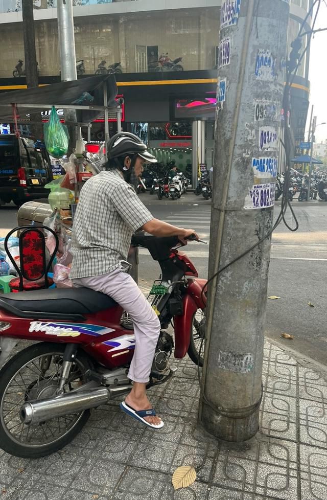6일 베트남 하노이에서 한 오토바이 운전자가 입에 담배를 문 채 신호가 바뀌기를 기다리고 있다. 하노이=허경주 특파원