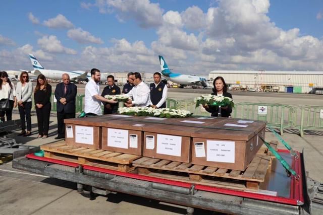 19일 이스라엘 텔아비브 벤구리온 공항에서 판나바 찬드라라마야(오른쪽 세 번째) 주이스라엘 태국대사가 이스라엘-하마스 전쟁으로 숨진 태국인 노동자들의 시신 운구를 준비하고 있다. 태국 외무부 제공