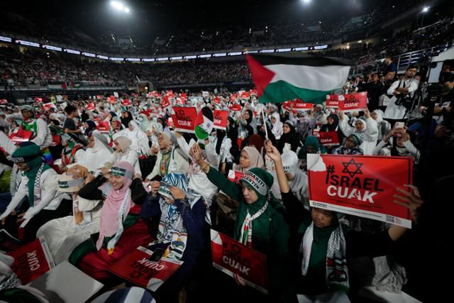 24일 말레이시아 쿠알라룸푸르에서 열린 팔레스타인 지지 집회에서 시민들이 팔레스타인 국기를 들고 연대 의지를 표현하고 있다. 쿠알라룸푸르=AP 연합뉴스