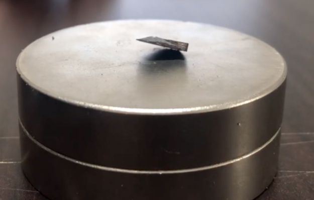 퀀텀에너지연구소가 공개한 상온 초전도체 LK-99. 자석(둥근 물체) 위에서 상당 부분이 공중에 떠 있다. 퀀텀에너지연구소 제공