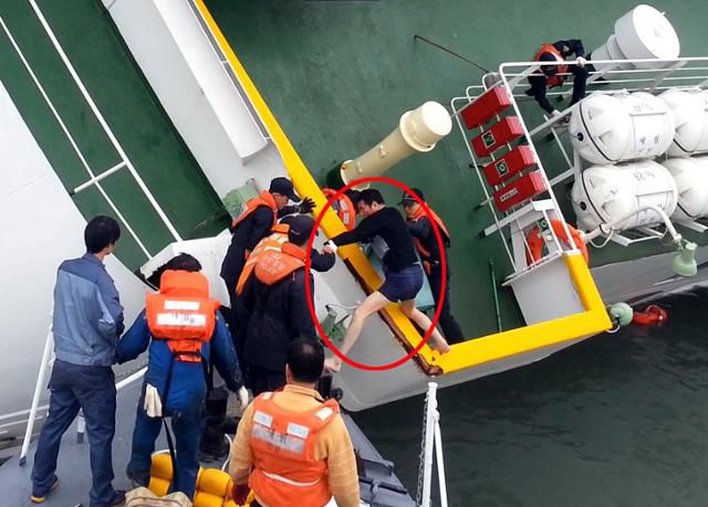 세월호 선장인 이준석이 참사 당시 승객들을 버려둔 채 속옷 차림으로 해경정에 올라타고 있다. 해경 제공