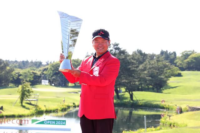 최경주가 19일 제주 서귀포시 핀크스 골프클럽에서 열린 한국프로골프(KPGA) 투어 SK텔레콤 오픈에서 2차 연장 접전 끝에 KPGA 최고령 우승을 달성한 후 빨간 재킷을 입은 채 우승 트로피를 들고 환하게 웃고 있다. KPGA 제공