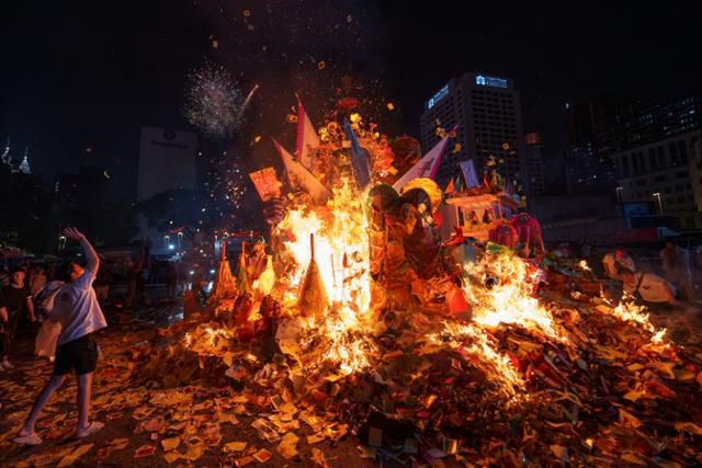 말레이시아 쿠알라룸푸르에서 19일 배고픈 귀신들의 축제인 '헝그리 고스트 페스티벌(아귀축제)'이 열려 말레이시아 중국인들이 거대한 귀신의 수호신상 앞에서 기도를 하고 있다. 음력 7월에 열리는 아귀축제에서는 저승문이 열리며 나온 영혼들을 달래기 위해 음식을 바치거나 가짜 돈을 태운다. 쿠알라룸푸르=AP 연합뉴스
