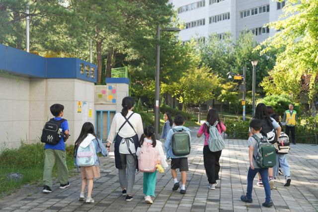 지난달 24일 오전 서울 중랑구 우리동네키움센터 중랑1호점 돌봄교사가 아침돌봄 이용 가정 아이들을 인근 새솔초등학교로 등교시키고 있다. 중랑구 제공