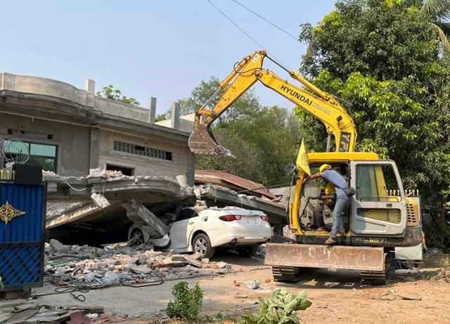 3일 미얀마 사가잉에서 한 구조대원이 굴착기로 외벽이 무너진 집을 복구하고 있다. 사가잉=허경주 특파원