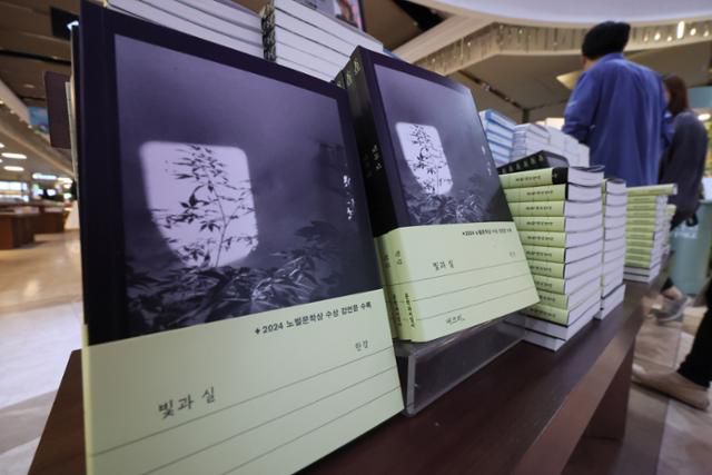 한강 작가의 노벨문학상 수상 후 첫 신간인 '빛과 실'이 24일 서울 종로구 교보문고 광화문점에 진열돼 있다. 책 표지는 작가가 직접 찍은 집 정원이다. 작가는 책에 실린 산문 '북향 정원'에서 거울로 햇빛을 붙잡아 나무들에게 비춰주면 흰 북쪽 벽에 빛의 창문이 생긴다며 잎과 가지들의 그림자가 그 안에서 음각화 같은 형상을 만든다고 적었다. 연합뉴스