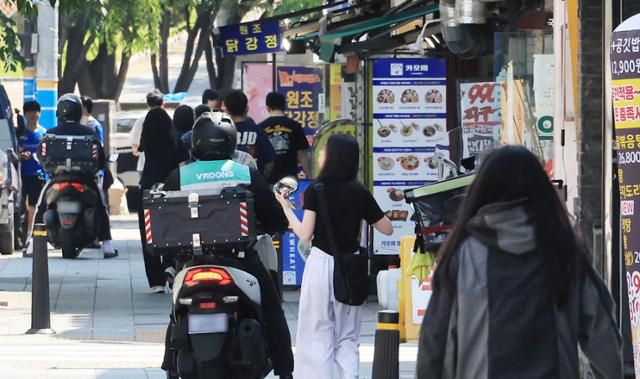 25일 서울 시내 한 음식점 앞에서 배달 라이더가 배달을 준비하고 있다. 연합뉴스
