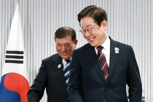 주요 7개국(G7) 정상회의 참석차 캐나다 앨버타주 캐내내스키스를 찾은 이재명 대통령이 17일 열린 한일 정상회담에서 이시바 시게루 일본 총리와 자리를 바꾸며 밝게 웃고 있다. 왕태석 선임기자
