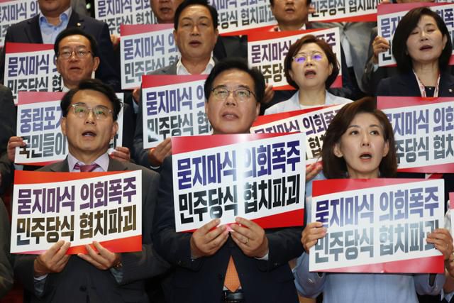 송언석(앞줄 가운데) 국민의힘 원내대표와 의원들이 27일 서울 여의도 국회에서 상임위원장 선출을 위한 본회의에 불참하고 로텐더홀 앞 계단에서 더불어민주당 규탄대회를 하고 있다. 뉴스1