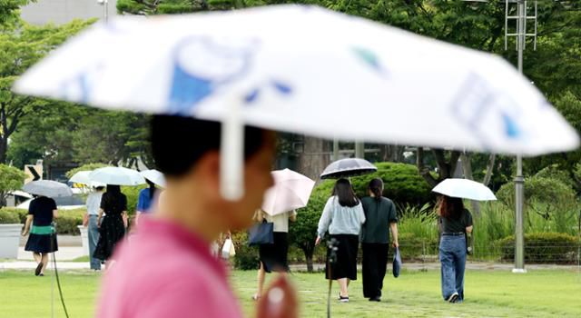 연일 무더운 날씨가 지속되고 있는 9일 전북 전주시 전북특별자치도청 앞에서 시민들이 양산을 펼쳐 들고 따가운 햇빛을 막으며 이동하고 있다. 뉴스1