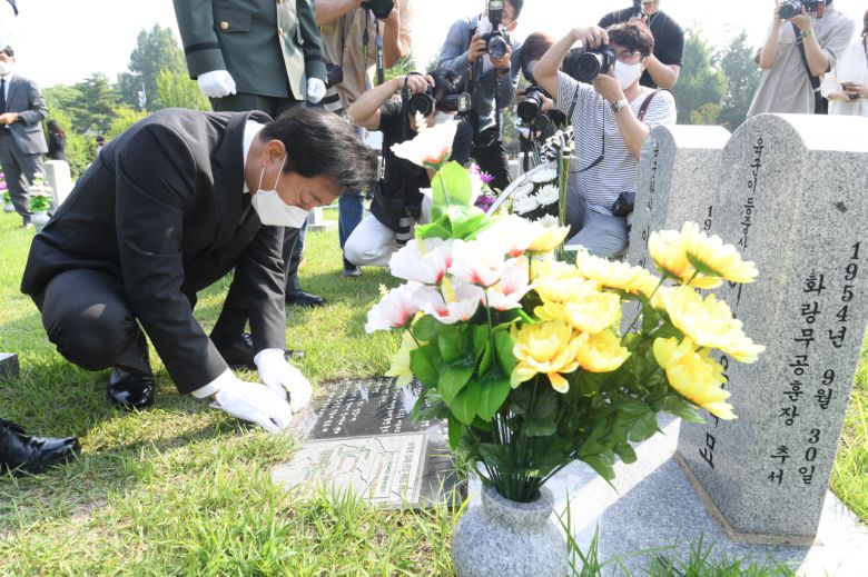 오세훈 서울시장이 6.25 전쟁 71주년을 맞은 25일 오전 9시 군 복무 중 사고를 당한 청년유공자인 하재헌 조정선수, 이주은 해병대위, 모델 이찬호씨와 함께 국립서울현충원을 참배한 후 한 전사자의 이력을 읽고 있다. [서울시 제공]