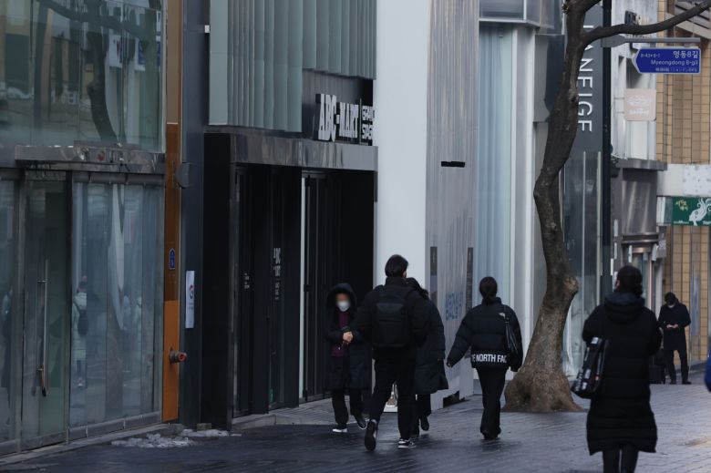 서울 중구 명동의 한 거리에서 빈 상가들 앞으로 시민이 지나가고 있다. [연합]