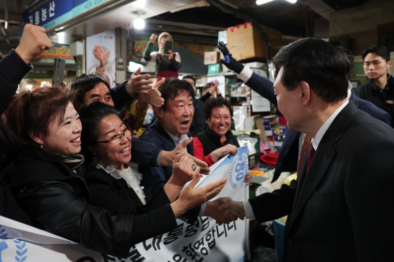 윤석열 대통령이 7일 대구 북구 칠성종합시장을 방문, 시민들과 반갑게 인사하고 있다. [연합]