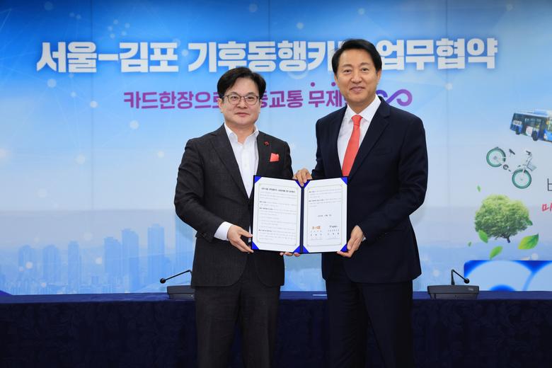 오세훈 서울시장과 김병수 김포시장이 7일 오전 서울시청 영상회의실에서 열린 서울-김포 기후동행카드 확대참여 업무협약식에서 협약서에 서명한 뒤 기념 촬영하고 있다.[연합]